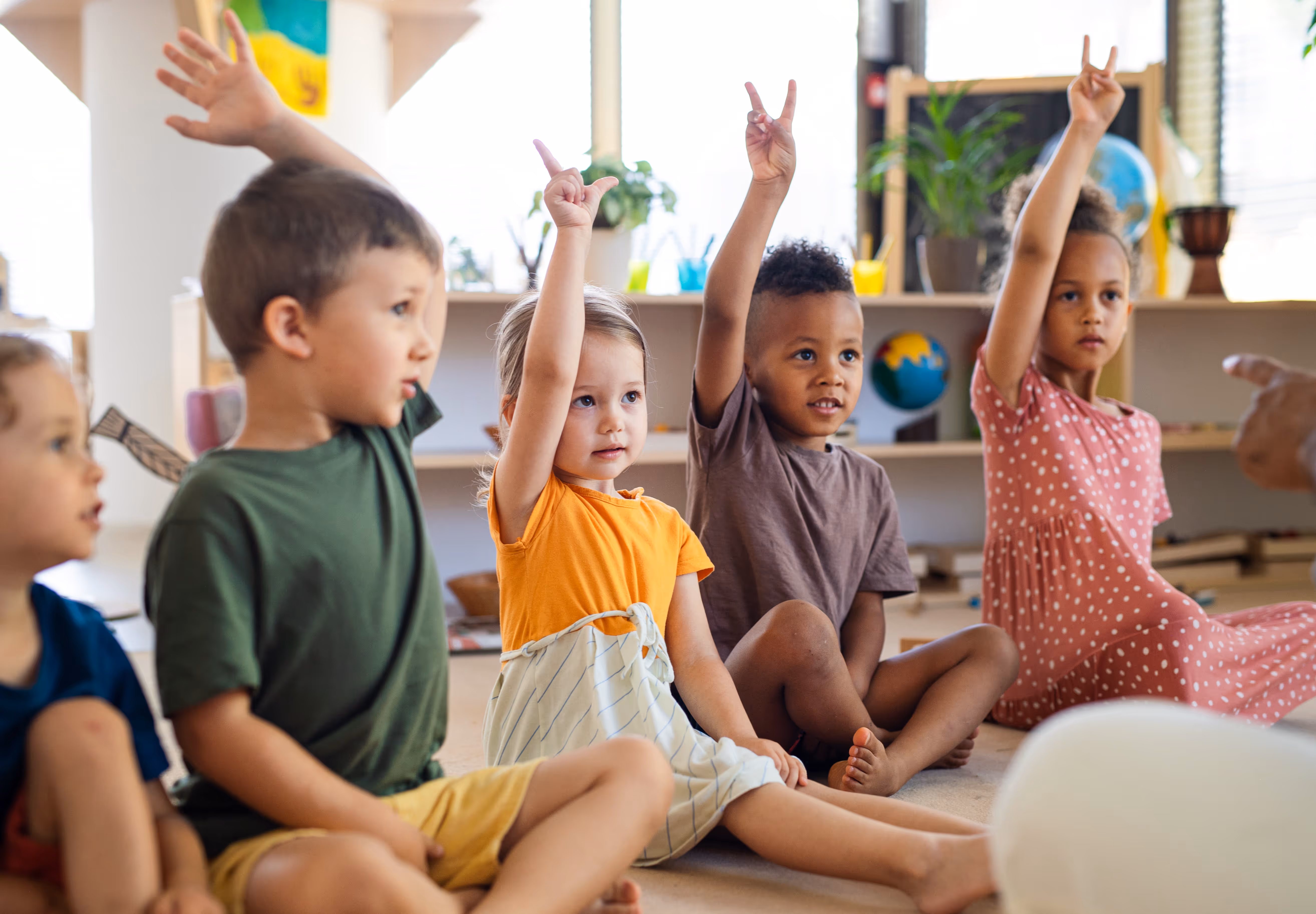 Students raising hands in a classroom